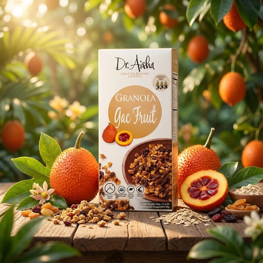 Box of Dr. Aisha Granola with grapefruit on a wooden surface with grapefruit and leaves in the background.